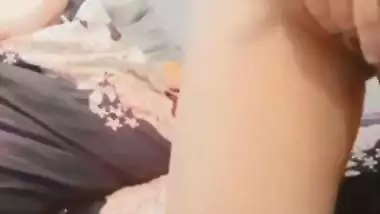 The naked girl fingers her wet pussy during a video call sex