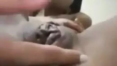 An Indian nude girl fingers her shaved pussy and ass
