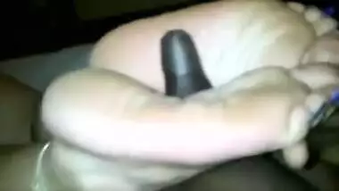 Indian woman with long toenails giving footjob